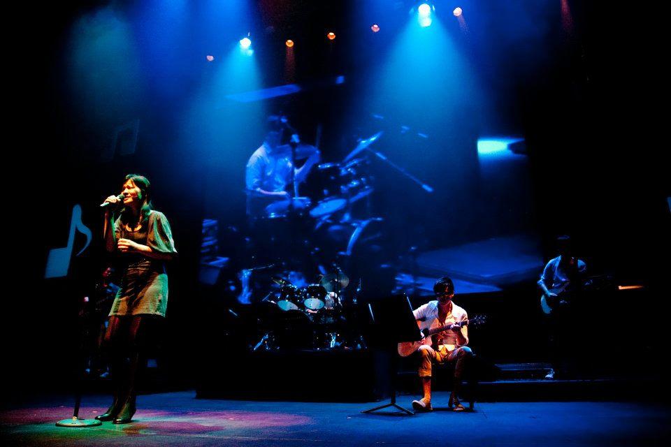 Live band performance with dramatic lighting
